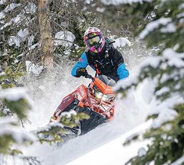 Athlete Chris Burandt riding a Polaris snowmobile with an ArcticFX Graphics wrap
